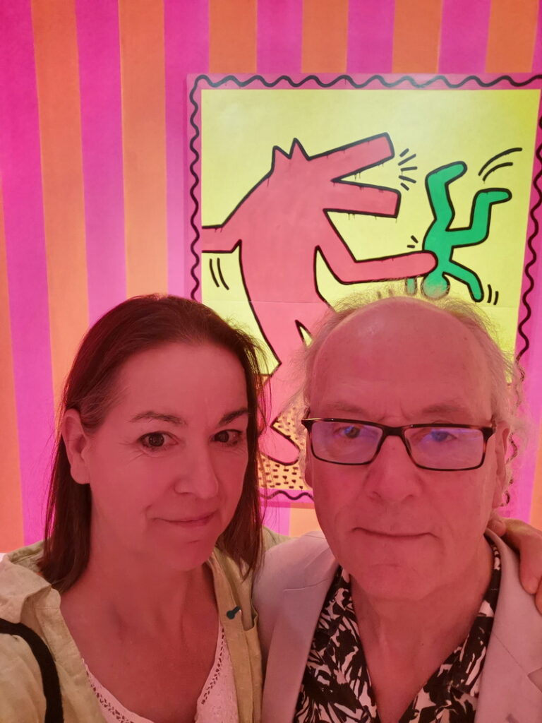 FRGlidden and A WOzniak stand next to each other in front of a Kieth Haring painting at the Walker art Center
